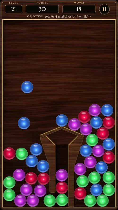 Real Rollabop gameplay screenshot: level 21, colourful glass balls piled in the walnut tray around a wooden divider